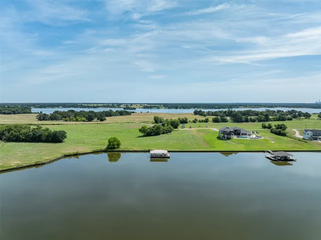 a view of a lake with houses in the back