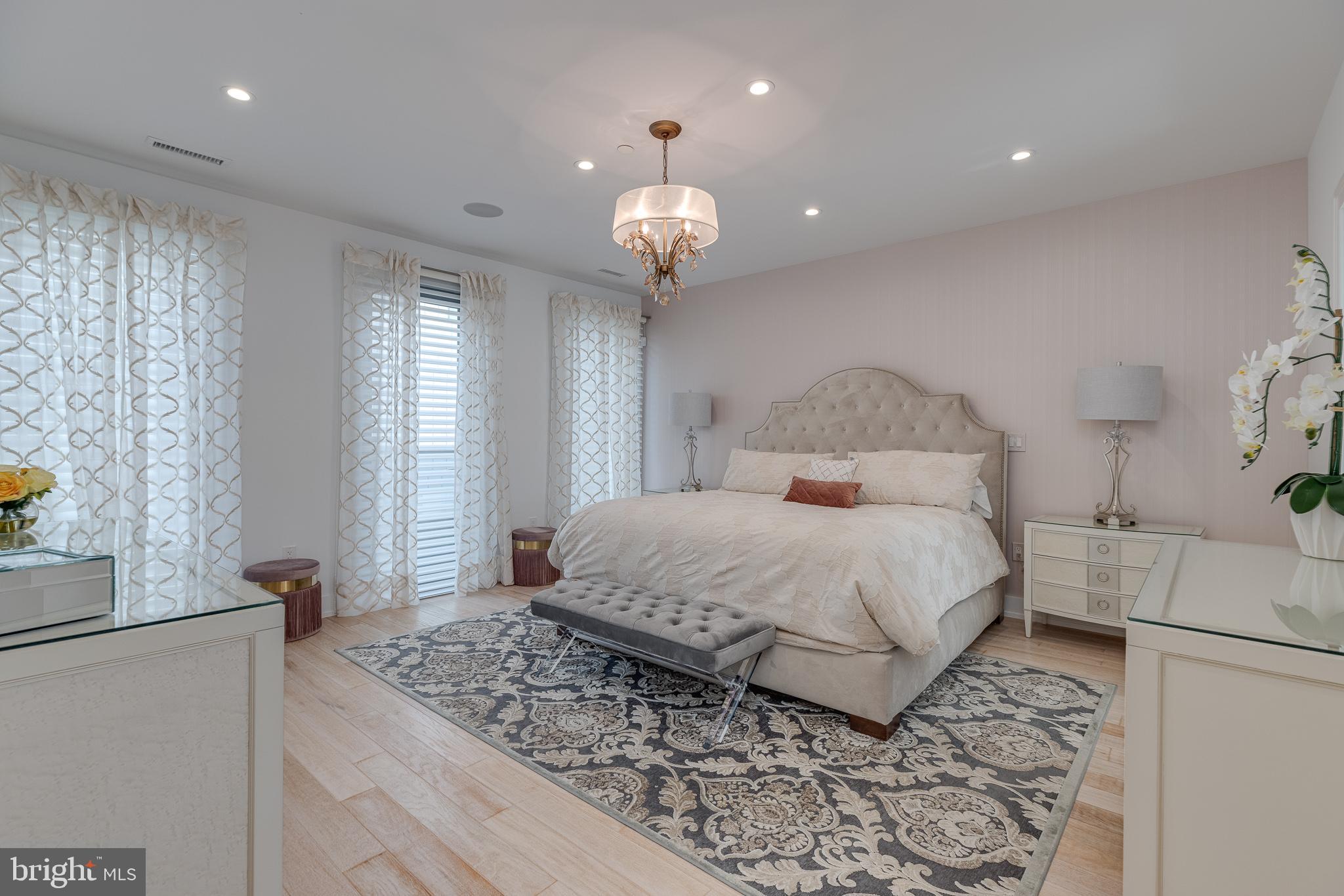249 South 24th Street, Unit C Philadelphia, PA 19103 - Photo 12 of 35 a bedroom with a large bed and a chandelier