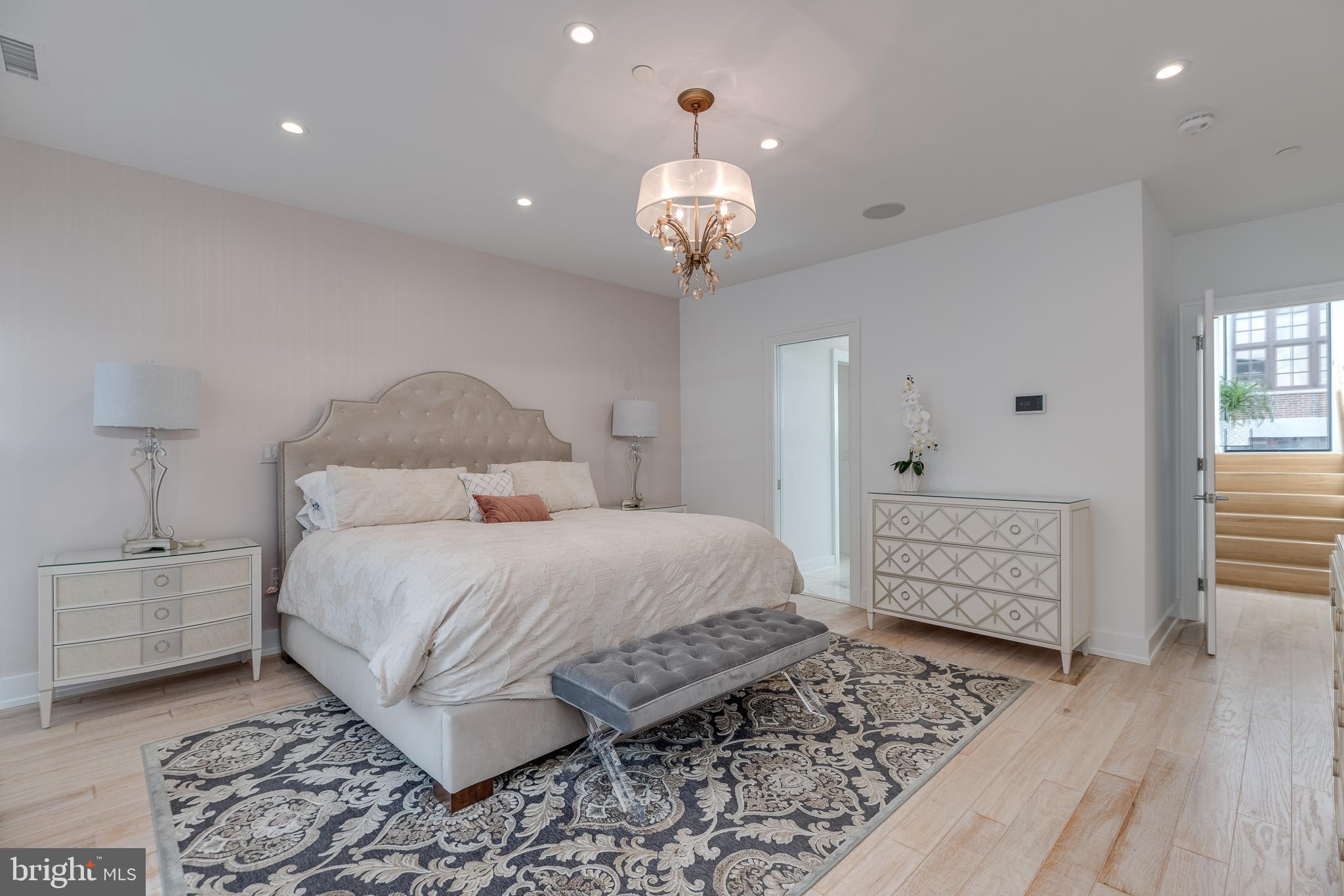 249 South 24th Street, Unit C Philadelphia, PA 19103 - Photo 13 of 35 a bedroom with a bed and a chandelier