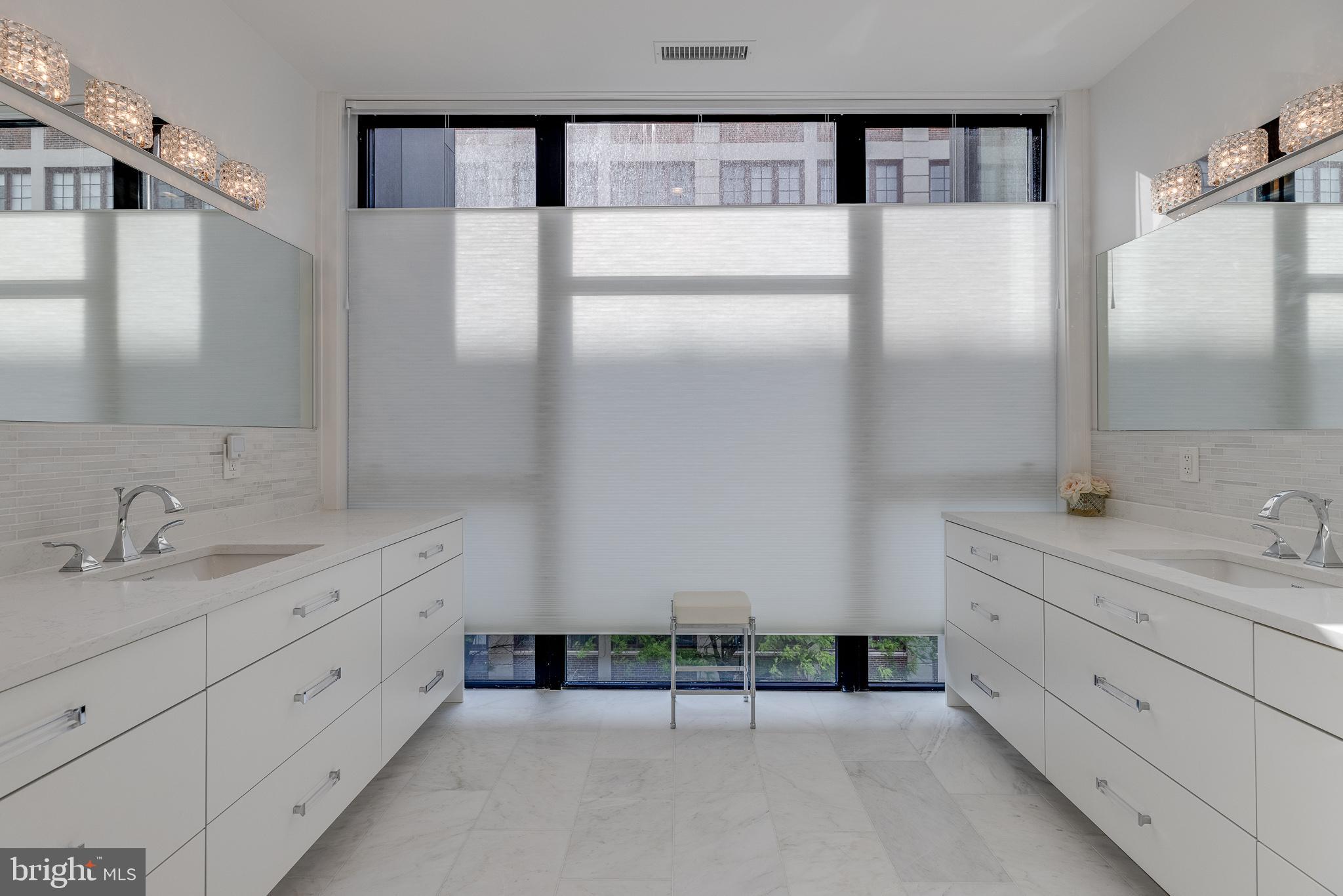 249 South 24th Street, Unit C Philadelphia, PA 19103 - Photo 16 of 35 a spacious bathroom with a double vanity sink a mirror and a shower