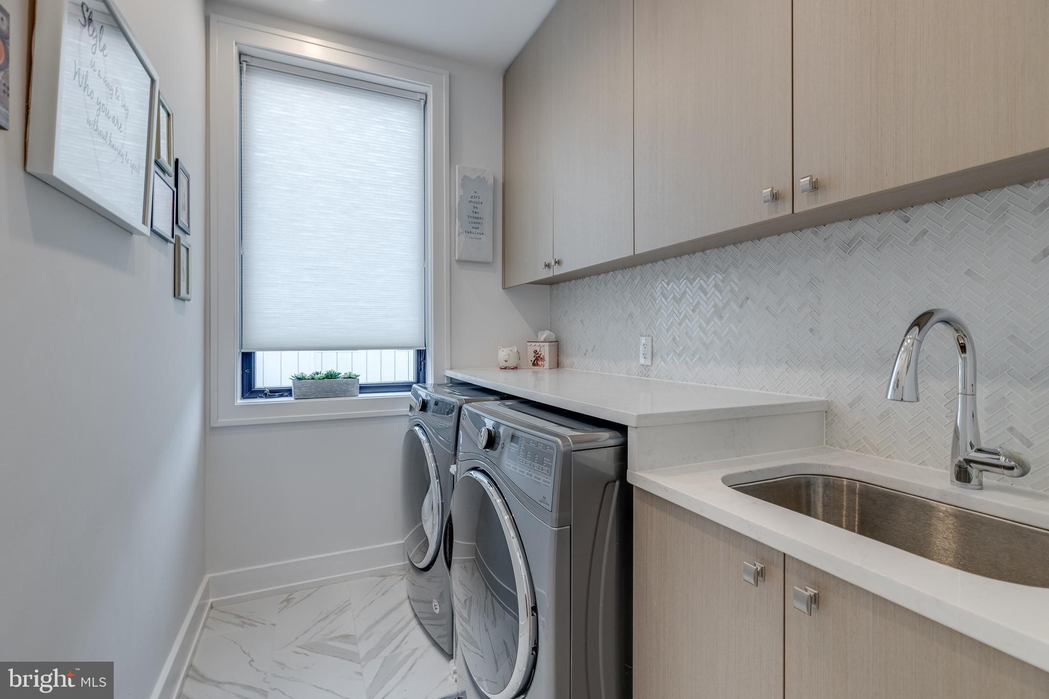 249 South 24th Street, Unit C Philadelphia, PA 19103 - Photo 21 of 35 a utility room with sink dryer and washer
