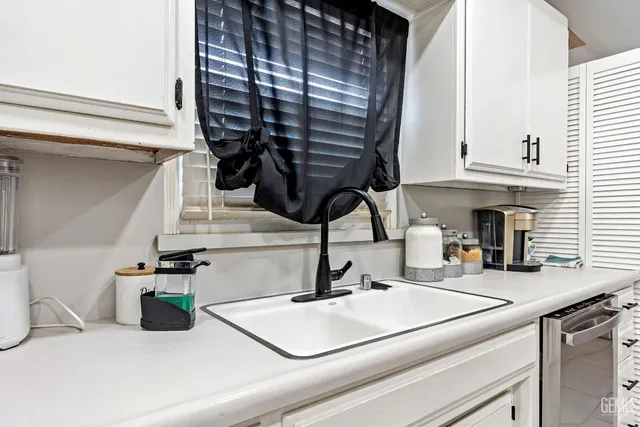 a kitchen with a sink and cabinets