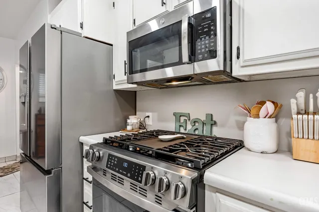 a stove top oven sitting inside of a kitchen