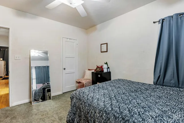 a bedroom with a bed and a mirror