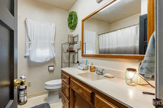 a bathroom with a sink a toilet and mirror
