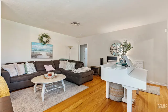 a living room with furniture and wooden floor
