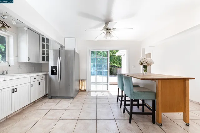 a kitchen with stainless steel appliances a refrigerator and a table