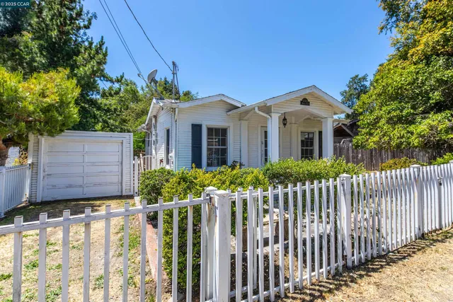 a front view of house with small garden