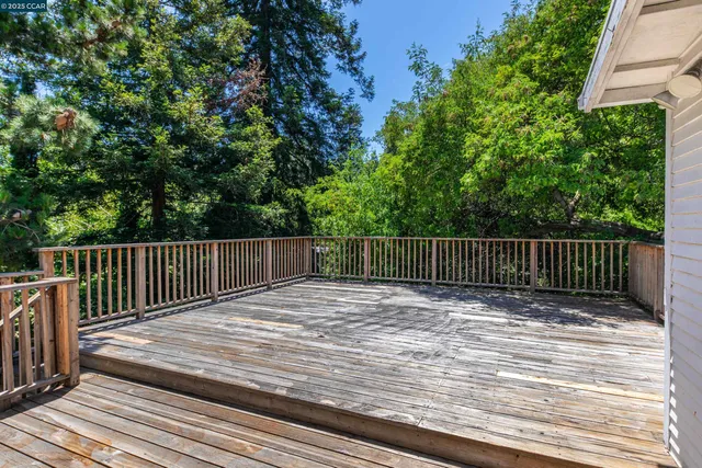 a balcony with view of trees in the background