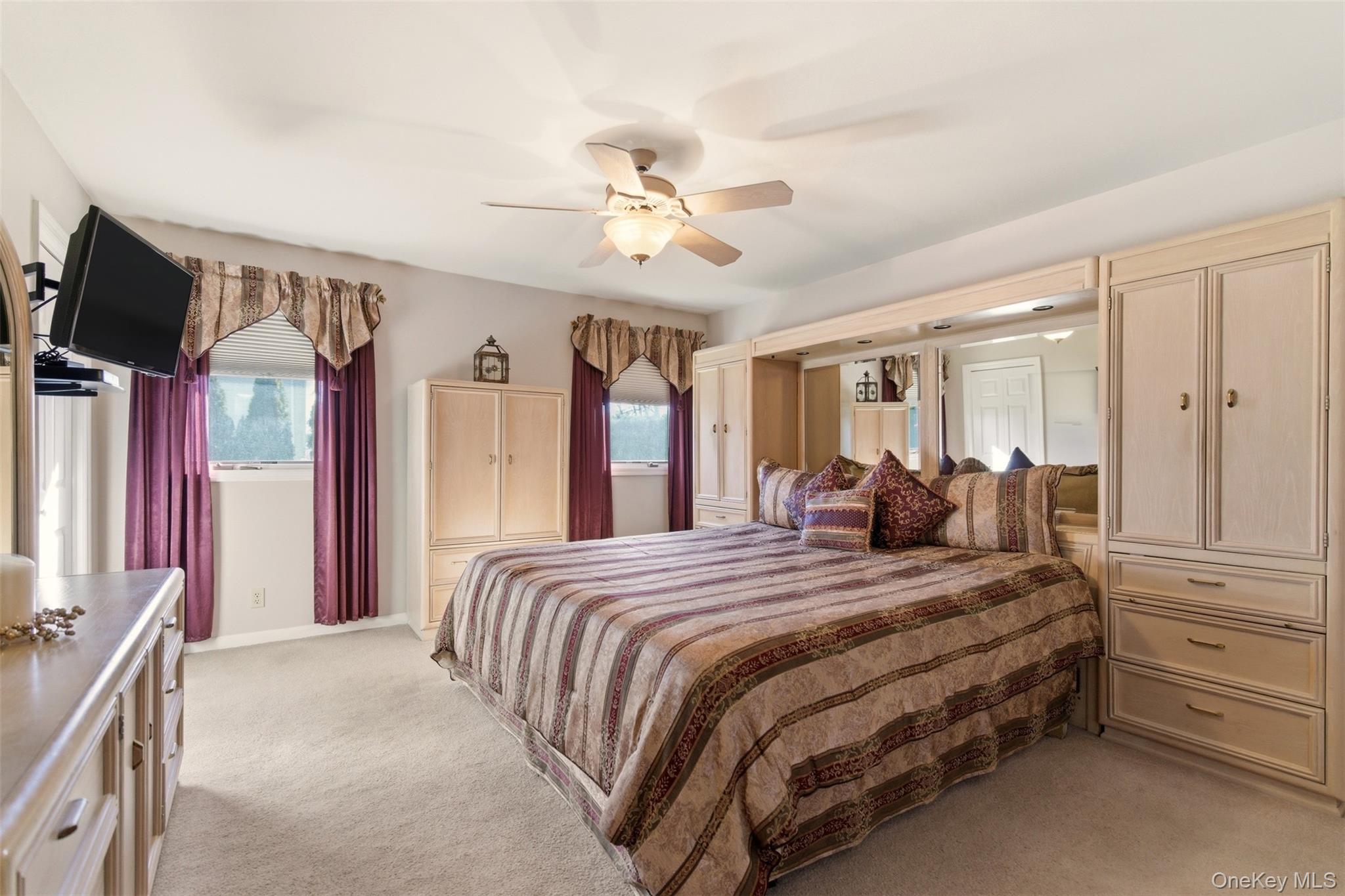 15 Leeward Lane Commack, NY 11725 - Photo 12 of 26 a bed room with a bed and a chandelier