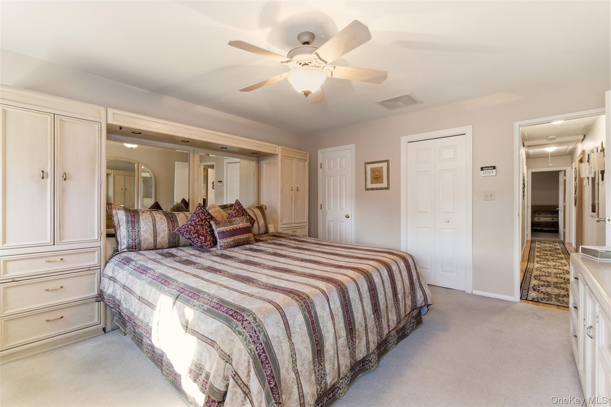 15 Leeward Lane Commack, NY 11725 - Photo 13 of 26 a spacious bedroom with a bed and closet