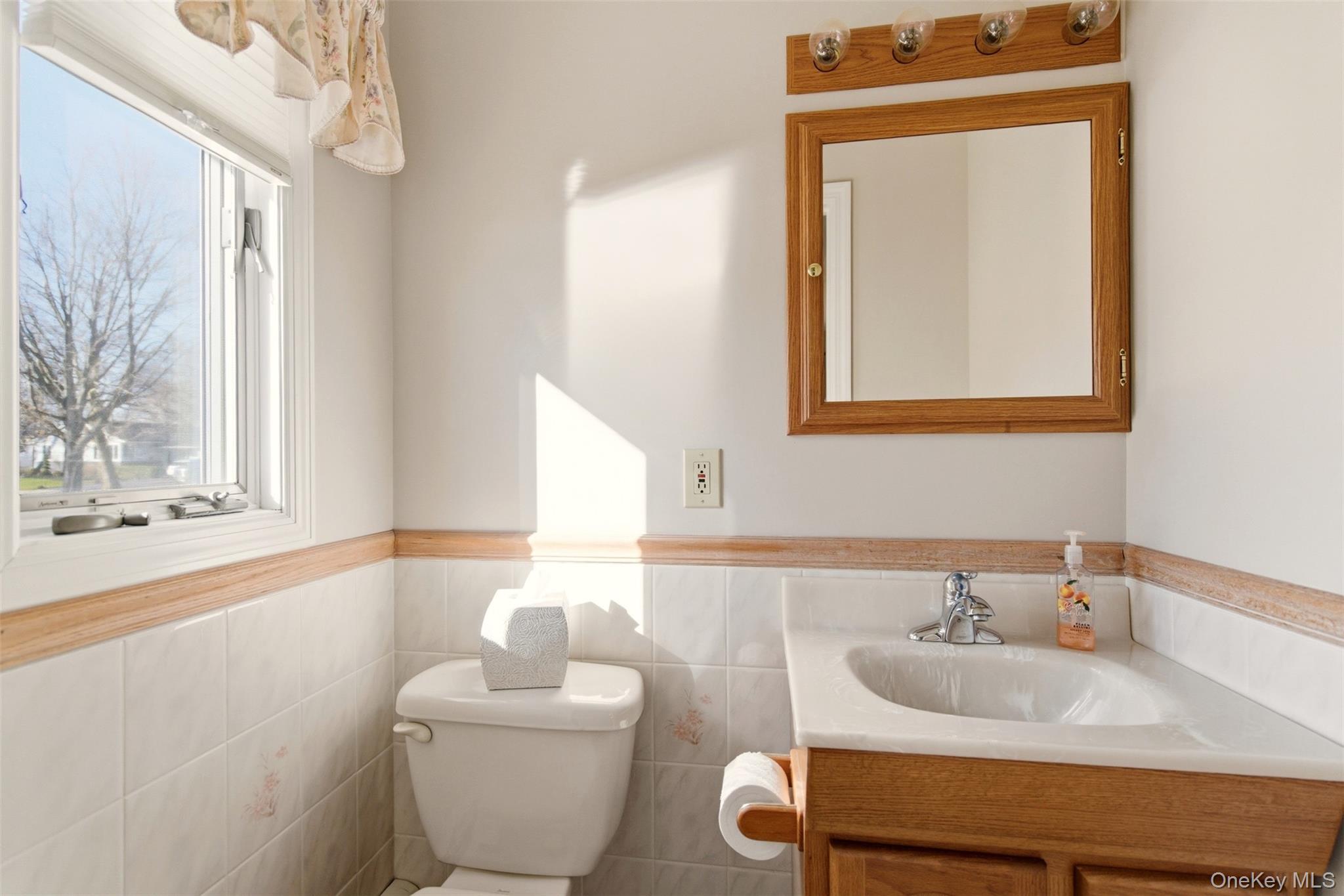 15 Leeward Lane Commack, NY 11725 - Photo 14 of 26 a bathroom with a toilet sink and mirror
