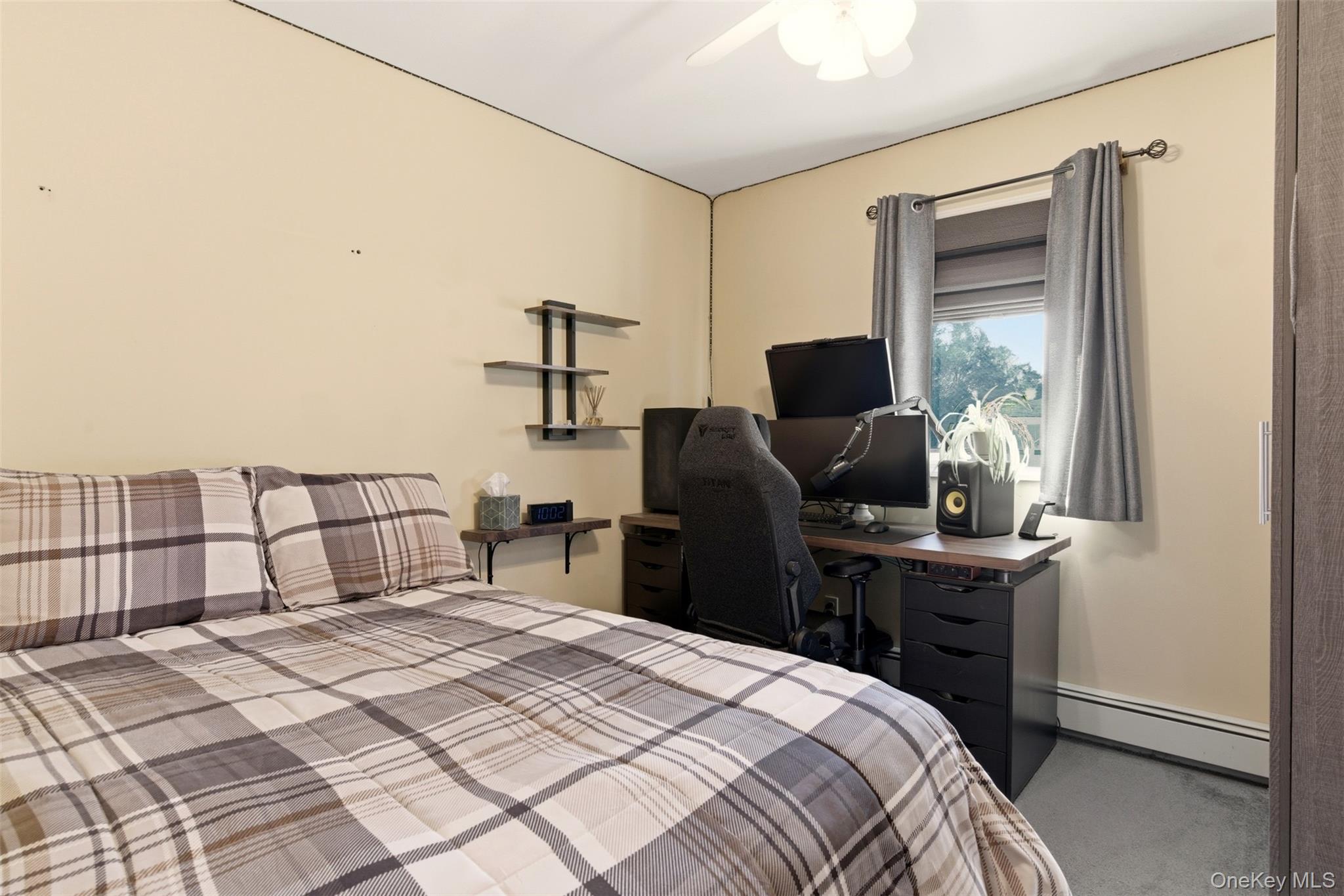 15 Leeward Lane Commack, NY 11725 - Photo 15 of 26 a bedroom with a bed and a flat screen tv