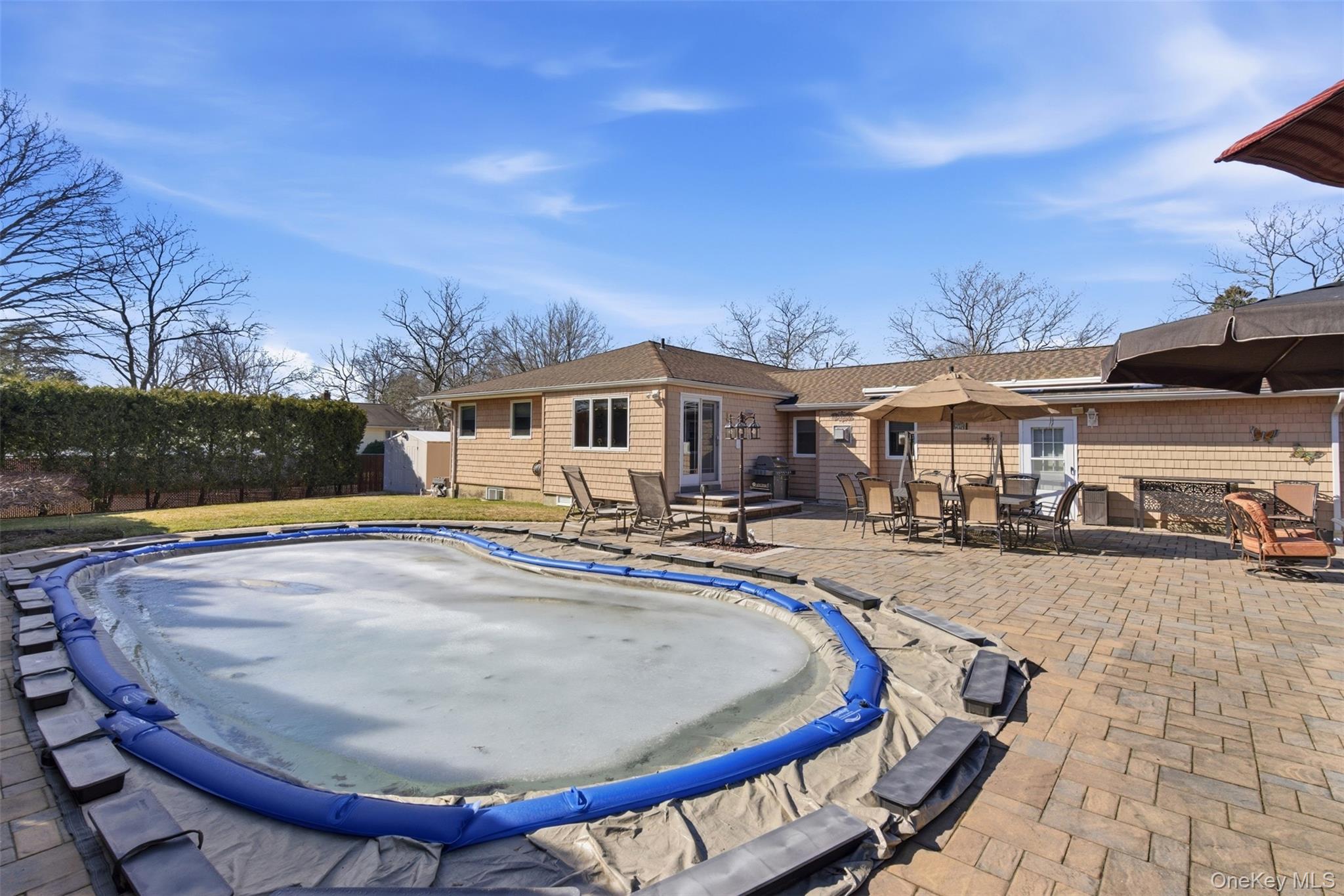 15 Leeward Lane Commack, NY 11725 - Photo 22 of 26 a view of a house with swimming pool and sitting area