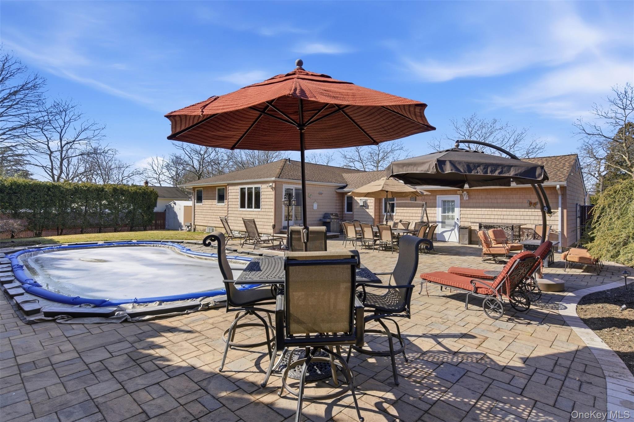 15 Leeward Lane Commack, NY 11725 - Photo 23 of 26 a view of patio with chairs and table under an umbrella
