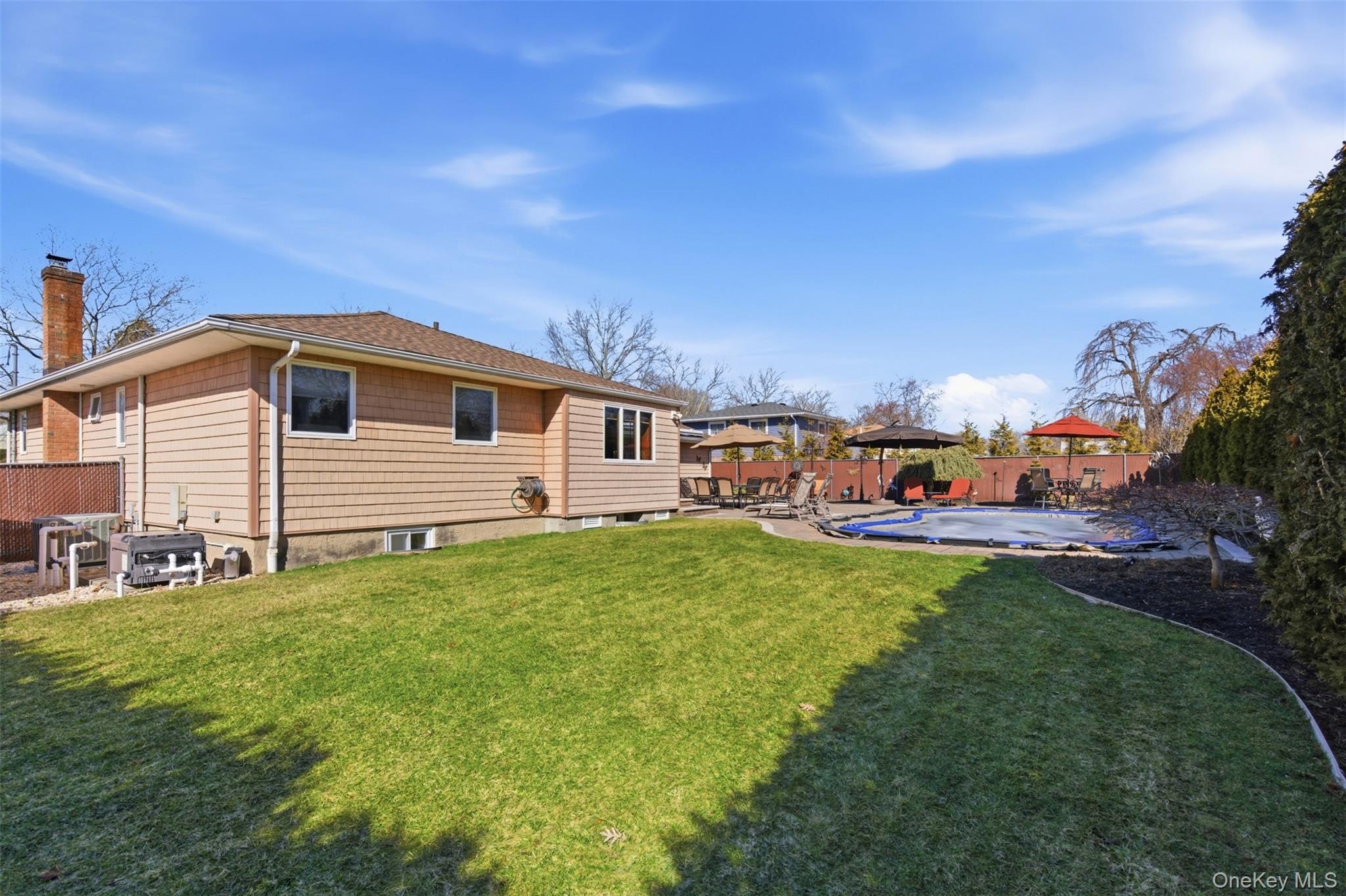 15 Leeward Lane Commack, NY 11725 - Photo 24 of 26 a view of a house with backyard and sitting area