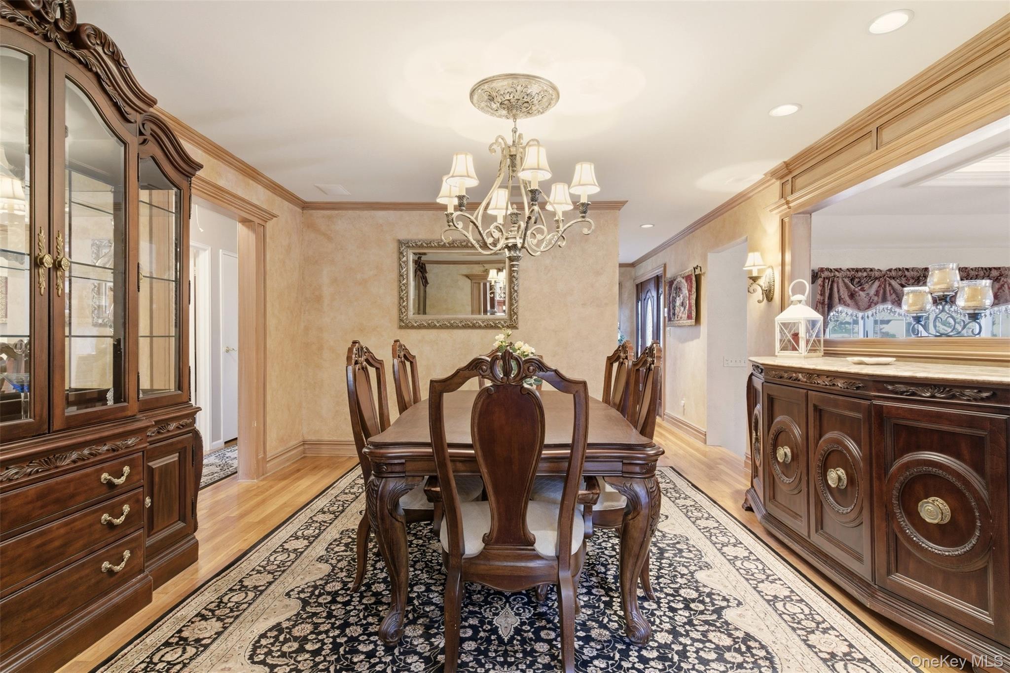 15 Leeward Lane Commack, NY 11725 - Photo 7 of 26 a view of a dining room with furniture and a chandelier