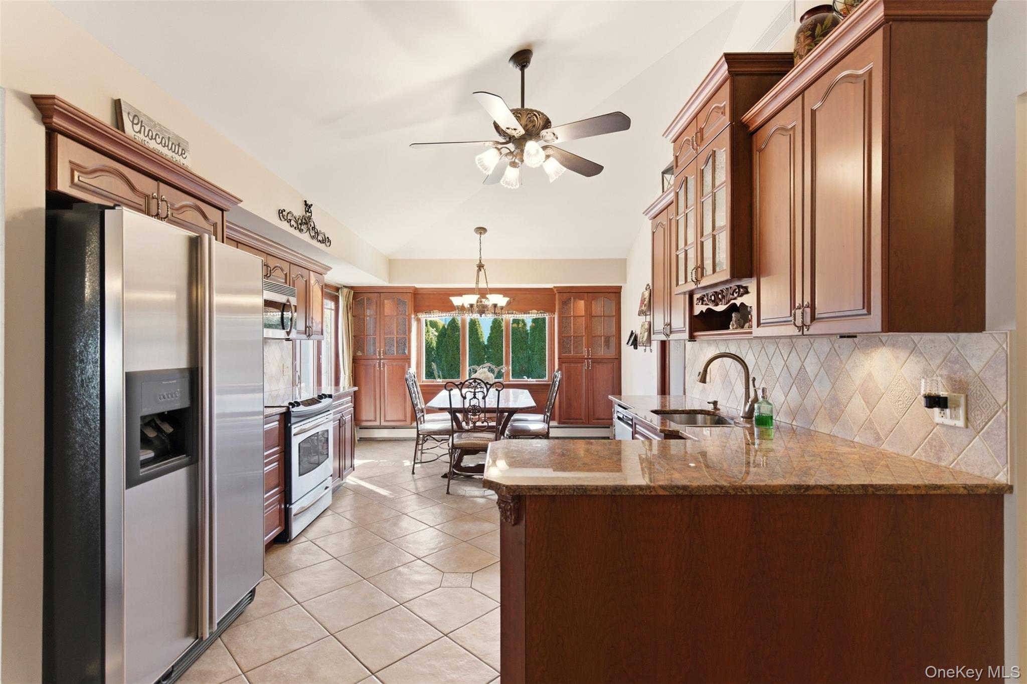 15 Leeward Lane Commack, NY 11725 - Photo 8 of 26 a kitchen with stainless steel appliances granite countertop a sink refrigerator and cabinets