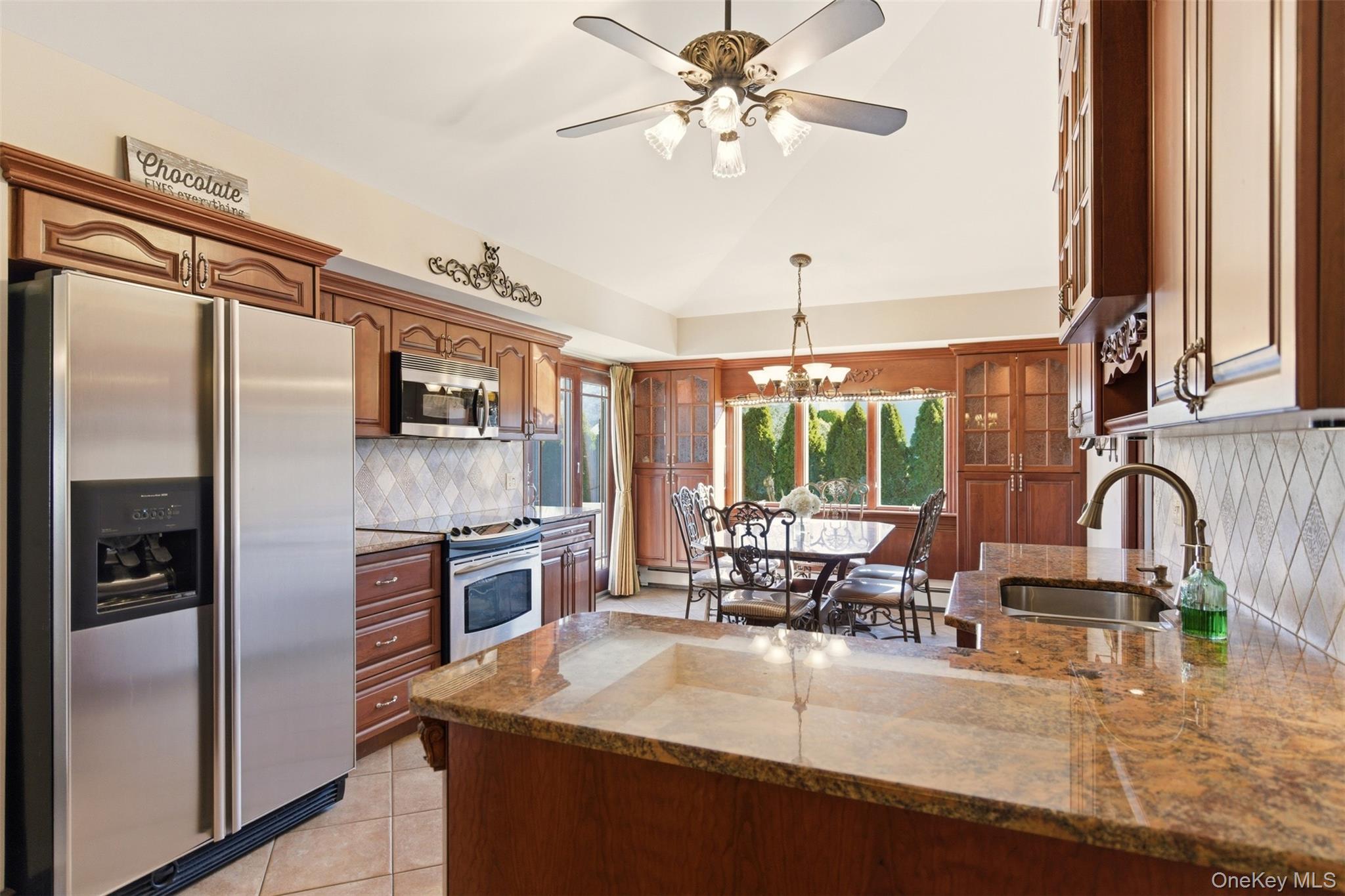 15 Leeward Lane Commack, NY 11725 - Photo 9 of 26 a kitchen with stainless steel appliances granite countertop a sink a stove and a refrigerator