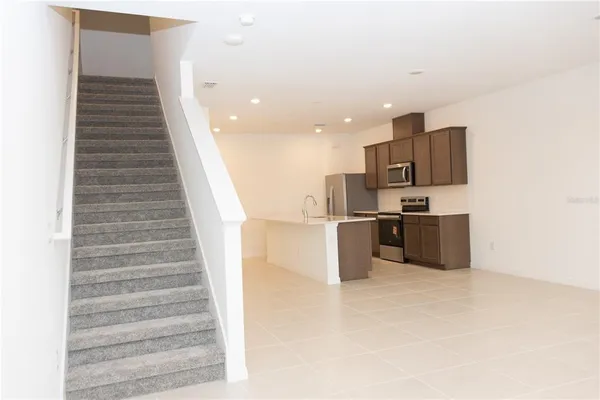 a kitchen with kitchen island and a refrigerator