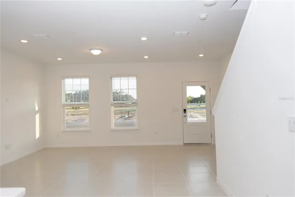 an empty room with windows and closet