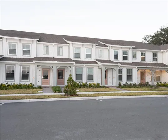 a front view of a residential apartment building with a yard