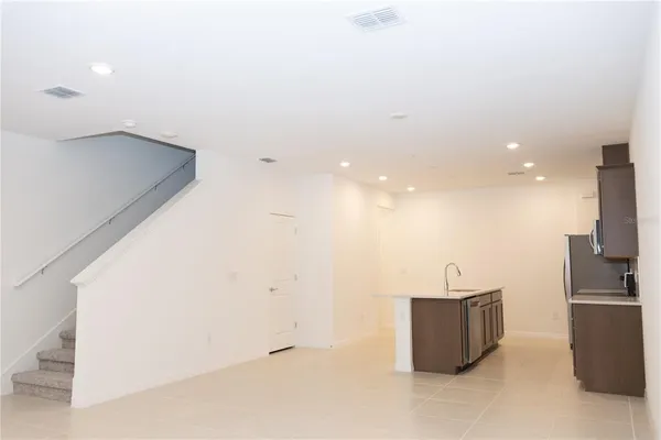 a kitchen with stainless steel appliances a refrigerator and a sink