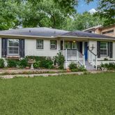 a front view of a house with a yard table and chairs