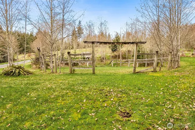 a view of yard with swimming pool and trees