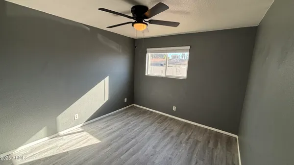 a view of room with window and ceiling fan
