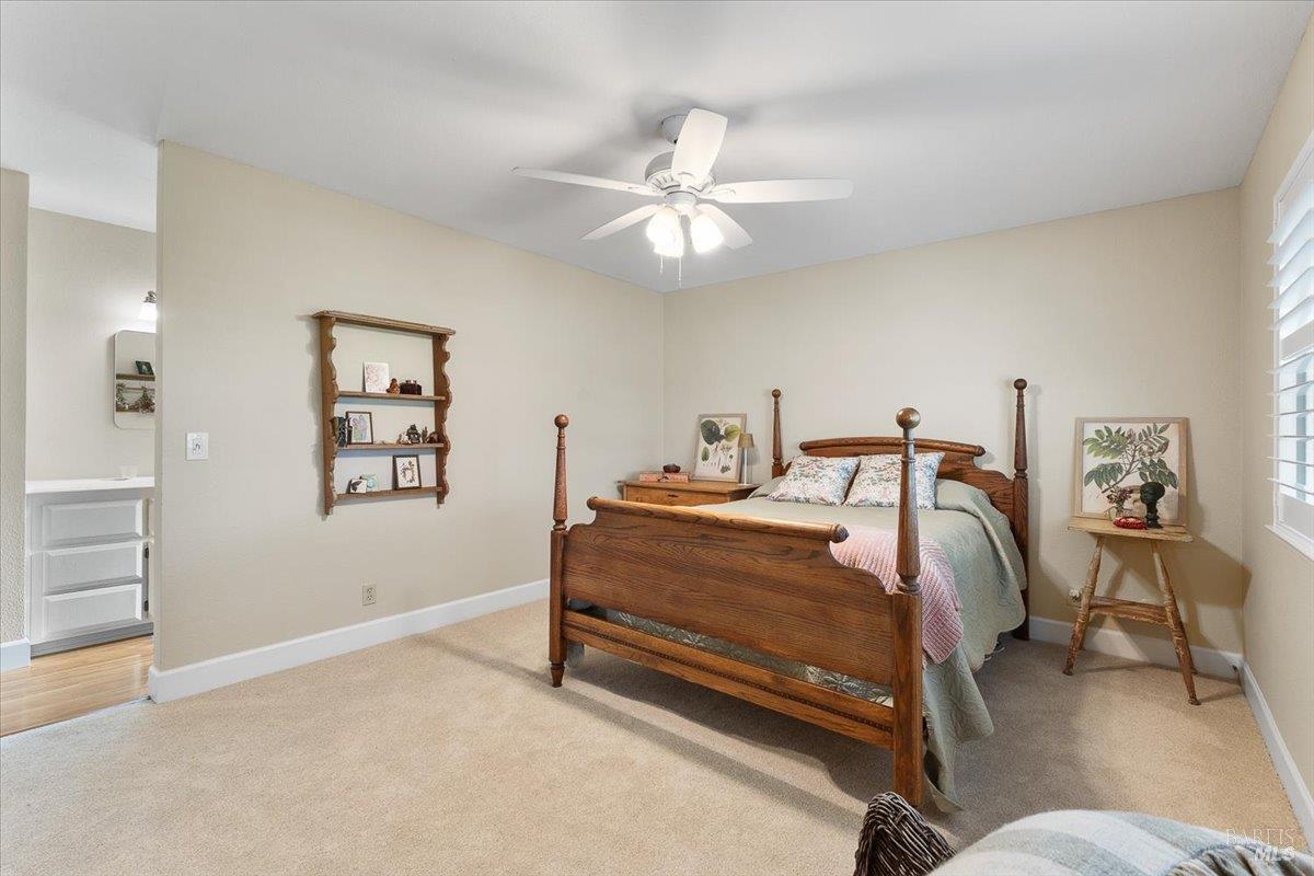 411 Twin Lakes Circle Santa Rosa, CA 95409 - Photo 28 of 41 a bedroom with a bed and a chandelier