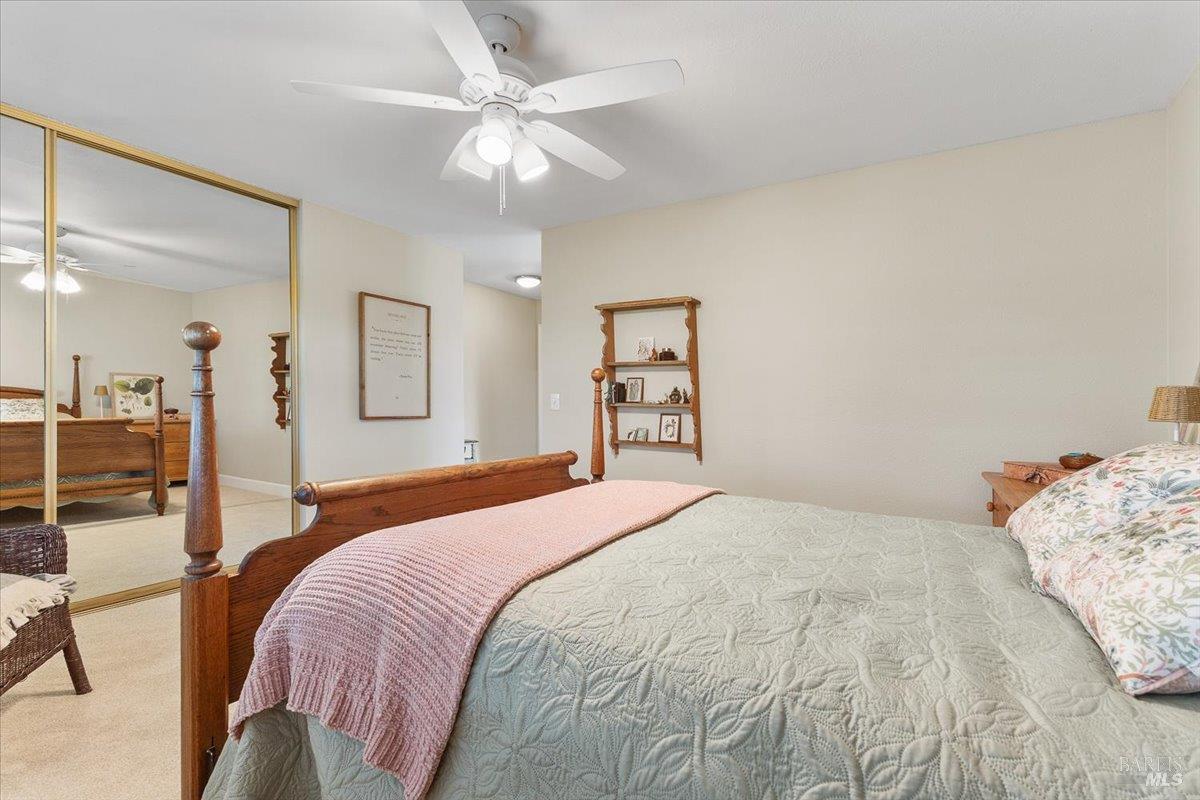 411 Twin Lakes Circle Santa Rosa, CA 95409 - Photo 29 of 41 a bedroom with a large bed and a chandelier