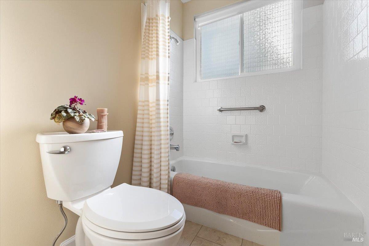 411 Twin Lakes Circle Santa Rosa, CA 95409 - Photo 31 of 41 a white toilet sitting next to a bathroom sink and tub