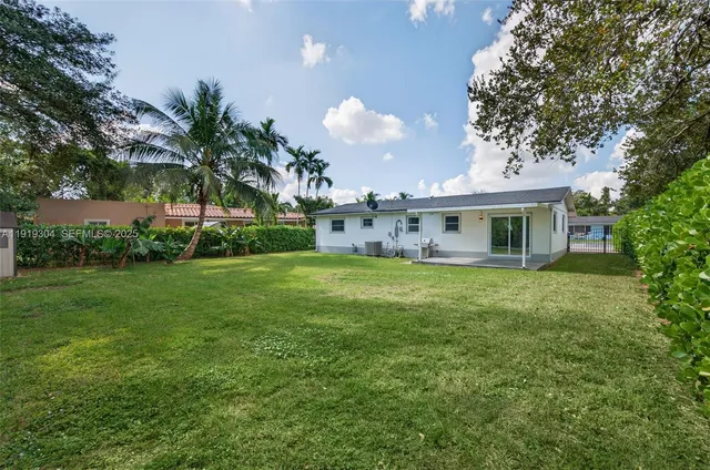 a view of a house with a yard and a garden
