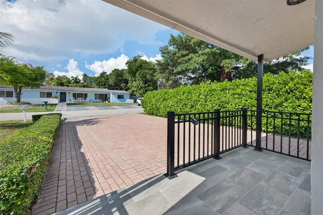 a view of a porch with wooden floor and fence