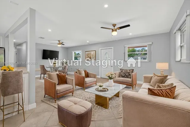 a view of a kitchen with kitchen island a counter top space stainless steel appliances and cabinets