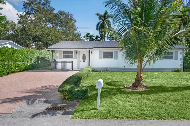 a front view of house with yard and green space