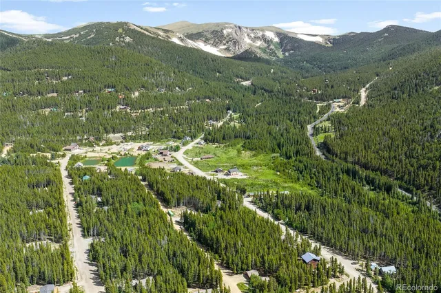 a view of a lush green hillside and mountains