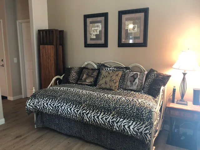 a bedroom with a bed and wooden floor