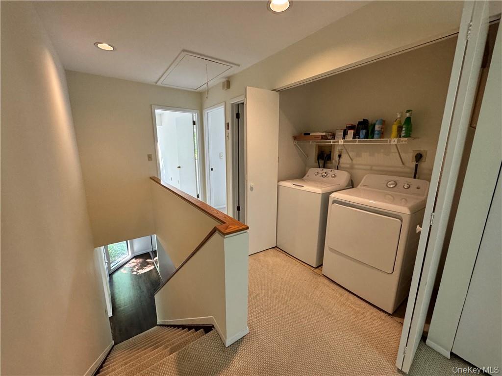 17 Rambling Brook Road Chappaqua, NY 10514 - Photo 25 of 32 View of second floor landing with stairs showcasing front door with double entry closet. Notice pull down stair for additional attic storage