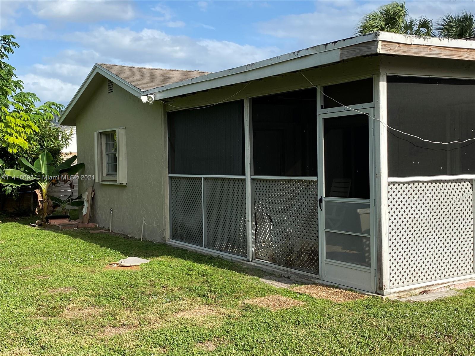 9191 Southwest 18th Road Boca Raton, FL 33428 - Photo 13 of 23 a backyard of a house with wooden fence
