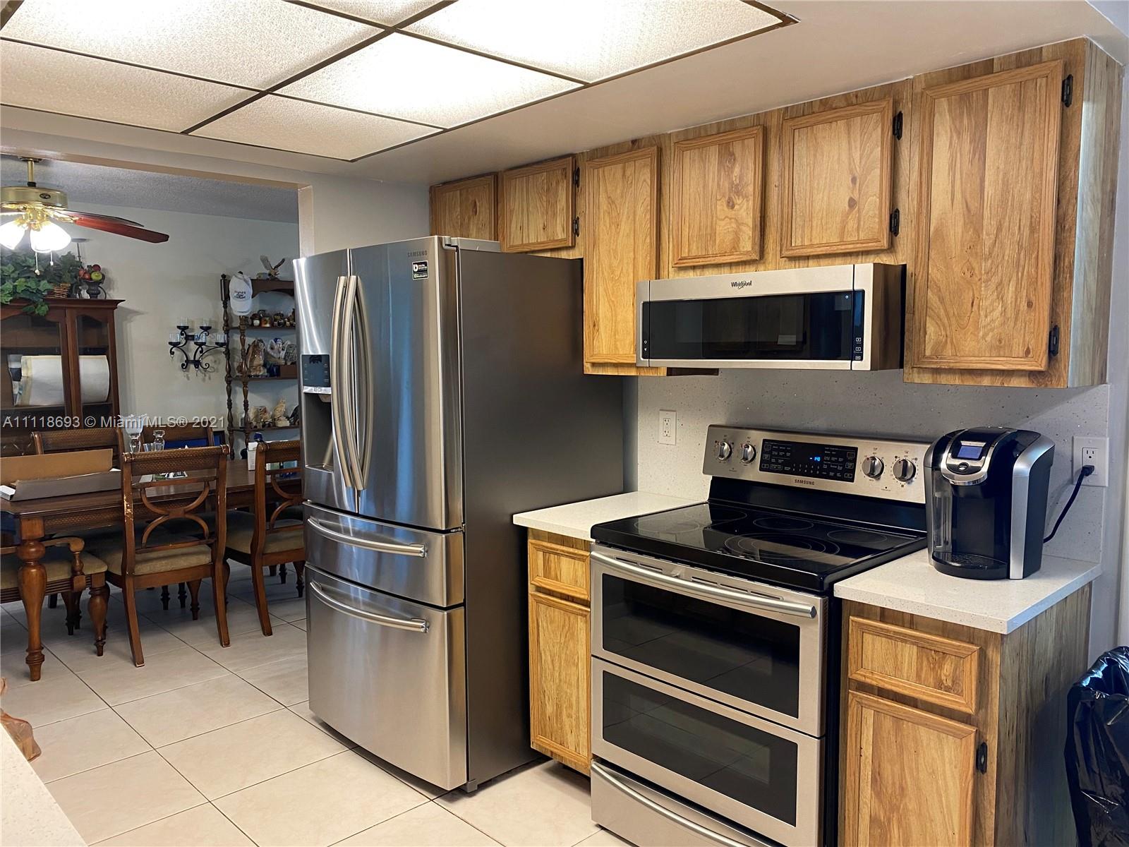 9191 Southwest 18th Road Boca Raton, FL 33428 - Photo 4 of 23 a kitchen with a stove a microwave and refrigerator