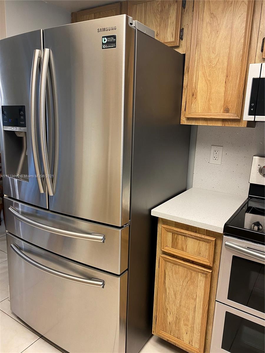 9191 Southwest 18th Road Boca Raton, FL 33428 - Photo 6 of 23 a metallic refrigerator freezer sitting in a kitchen