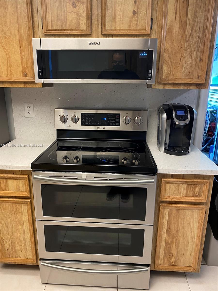 9191 Southwest 18th Road Boca Raton, FL 33428 - Photo 7 of 23 a stove top oven sitting inside of a kitchen