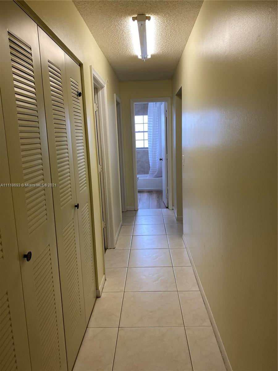 9191 Southwest 18th Road Boca Raton, FL 33428 - Photo 10 of 23 a view of hallway with a large window and a mirror