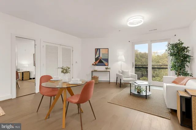 a dining room with furniture and wooden floor