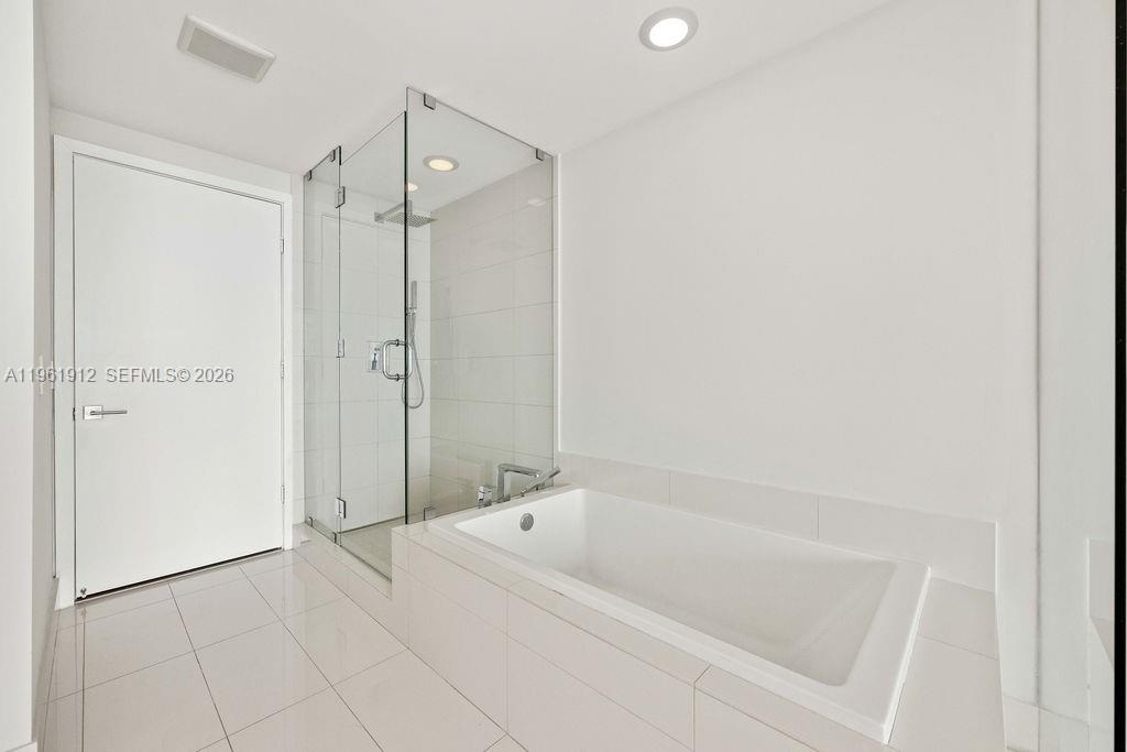 650 Northeast 32nd Street, Unit 2205 Miami, FL 33137 - Photo 11 of 56 a bathroom with a bathtub and a shower