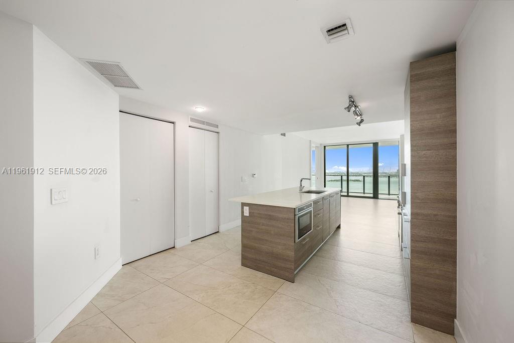 650 Northeast 32nd Street, Unit 2205 Miami, FL 33137 - Photo 17 of 56 a living room with furniture and a ceiling fan