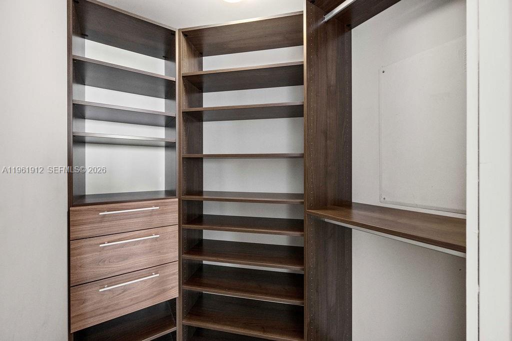 650 Northeast 32nd Street, Unit 2205 Miami, FL 33137 - Photo 22 of 56 a view of walk in closet with empty racks
