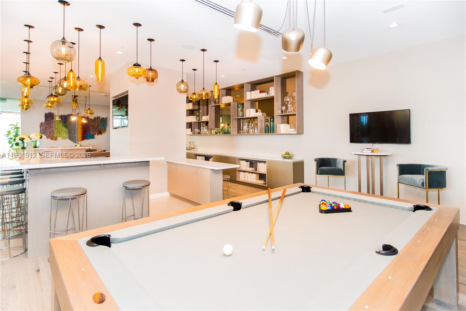 650 Northeast 32nd Street, Unit 2205 Miami, FL 33137 - Photo 39 of 56 a room with kitchen island a flat screen tv and appliances